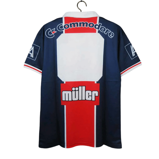 https://cdn.shopify.com/s/files/1/0826/7228/8075/files/19911992-paris-saint-germain-commodore-muller-home-retro-jersey-at-govintagejersey-326684.webp?v=1741199406