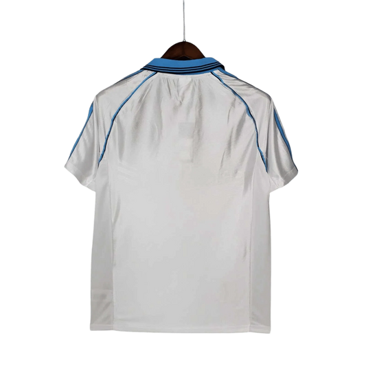 https://cdn.shopify.com/s/files/1/0826/7228/8075/files/19981999-olympique-de-marseille-ericsson-home-retro-jersey-729823.webp?v=1741199414