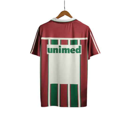 https://cdn.shopify.com/s/files/1/0826/7228/8075/files/2003-fluminense-unimed-home-retro-jersey-at-govintagejersey-819018.webp?v=1741197045