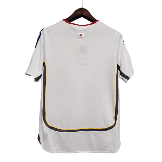 https://cdn.shopify.com/s/files/1/0826/7228/8075/files/2006-japan-away-retro-kit-391279.webp?v=1741197171