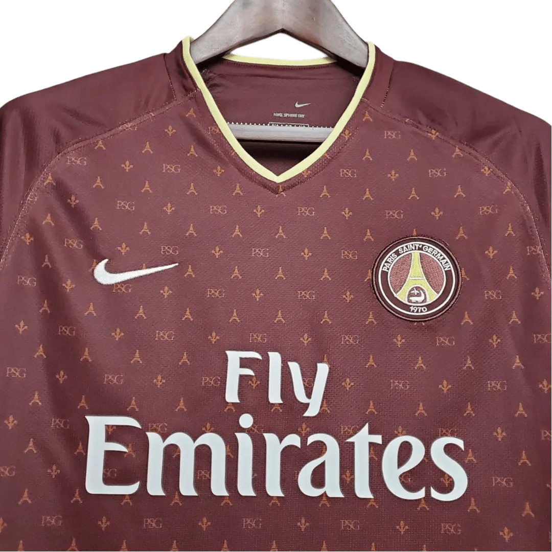 https://cdn.shopify.com/s/files/1/0826/7228/8075/files/20062007-paris-saint-germain-fly-emirates-away-red-retro-jersey-371717.webp?v=1741197866