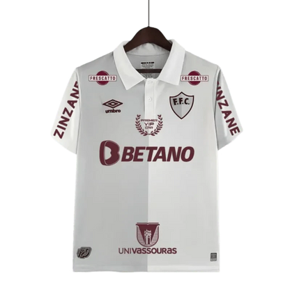 https://cdn.shopify.com/s/files/1/0826/7228/8075/files/120th-anniversary-fluminense-betano-white-grey-retro-kit-774693.webp?v=1741197183