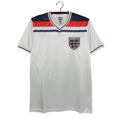 https://cdn.shopify.com/s/files/1/0826/7228/8075/files/1980-england-home-retro-kit-551336.webp?v=1741196942