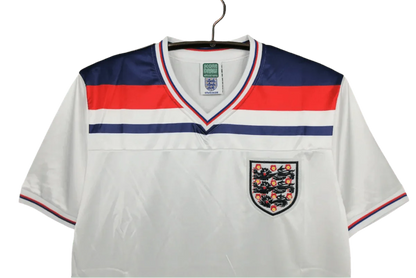 https://cdn.shopify.com/s/files/1/0826/7228/8075/files/1980-england-home-retro-kit-780747.webp?v=1741196940