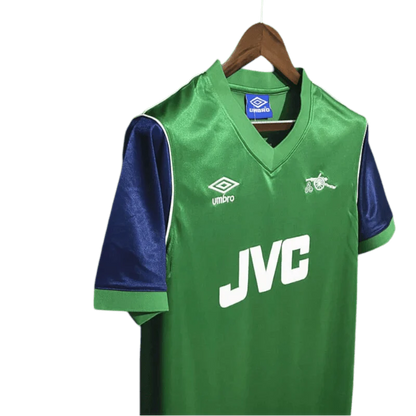 https://cdn.shopify.com/s/files/1/0826/7228/8075/files/19821983-arsenal-jvc-green-away-retro-kit-classickits433-896885.webp?v=1741199317