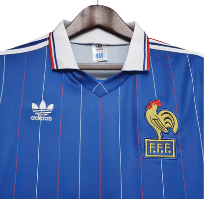 https://cdn.shopify.com/s/files/1/0826/7228/8075/files/19821983-france-home-retro-jersey-181018.webp?v=1741198522