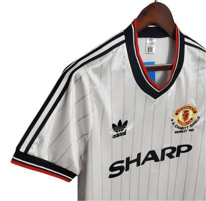 https://cdn.shopify.com/s/files/1/0826/7228/8075/files/19831984-manchester-united-sharp-fa-charity-shield-away-retro-kit-classickits433-861043.webp?v=1741199139