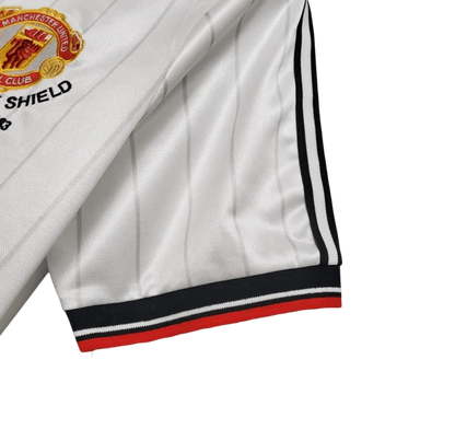 https://cdn.shopify.com/s/files/1/0826/7228/8075/files/19831984-manchester-united-sharp-fa-charity-shield-away-retro-kit-classickits433-994765.webp?v=1741199139