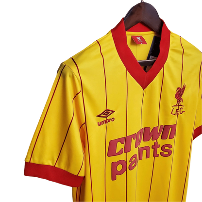 https://cdn.shopify.com/s/files/1/0826/7228/8075/files/19841985-liverpool-crown-paints-yellow-away-retro-kit-classickits433-698405.webp?v=1741199201