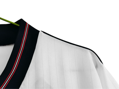 https://cdn.shopify.com/s/files/1/0826/7228/8075/files/19841987-england-home-retro-kit-691254.webp?v=1741196971