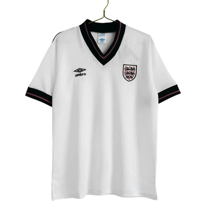https://cdn.shopify.com/s/files/1/0826/7228/8075/files/19841987-england-home-retro-kit-862431.webp?v=1741196968