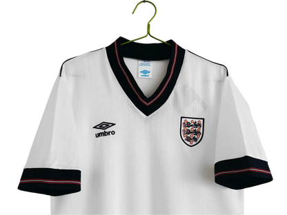 https://cdn.shopify.com/s/files/1/0826/7228/8075/files/19841987-england-home-retro-kit-981876.webp?v=1741196970