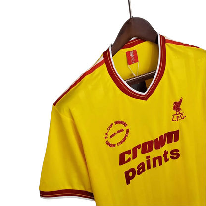 https://cdn.shopify.com/s/files/1/0826/7228/8075/files/19851986-liverpool-crown-paints-yellow-third-retro-kit-classickits433-891137.webp?v=1741197841