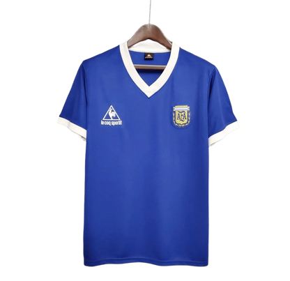 https://cdn.shopify.com/s/files/1/0826/7228/8075/files/1986-argentina-world-cup-away-retro-jersey-262352.webp?v=1741198513