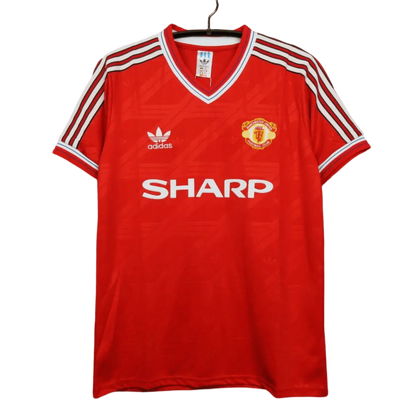 https://cdn.shopify.com/s/files/1/0826/7228/8075/files/19861988-manchester-united-sharp-home-retro-kit-classickits433-635440.webp?v=1741197616