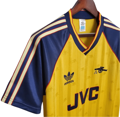 https://cdn.shopify.com/s/files/1/0826/7228/8075/files/19881989-arsenal-jvc-yellow-away-retro-kit-classickits433-341515.webp?v=1741199331