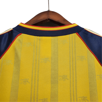 https://cdn.shopify.com/s/files/1/0826/7228/8075/files/19881989-arsenal-jvc-yellow-away-retro-kit-classickits433-709952.webp?v=1741199334