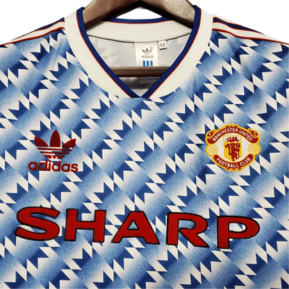 https://cdn.shopify.com/s/files/1/0826/7228/8075/files/19901992-manchester-united-sharp-blue-flower-away-retro-kit-classickits433-254964.webp?v=1741197759