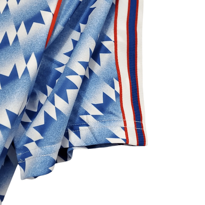 https://cdn.shopify.com/s/files/1/0826/7228/8075/files/19901992-manchester-united-sharp-blue-flower-away-retro-kit-classickits433-829435.webp?v=1741197759
