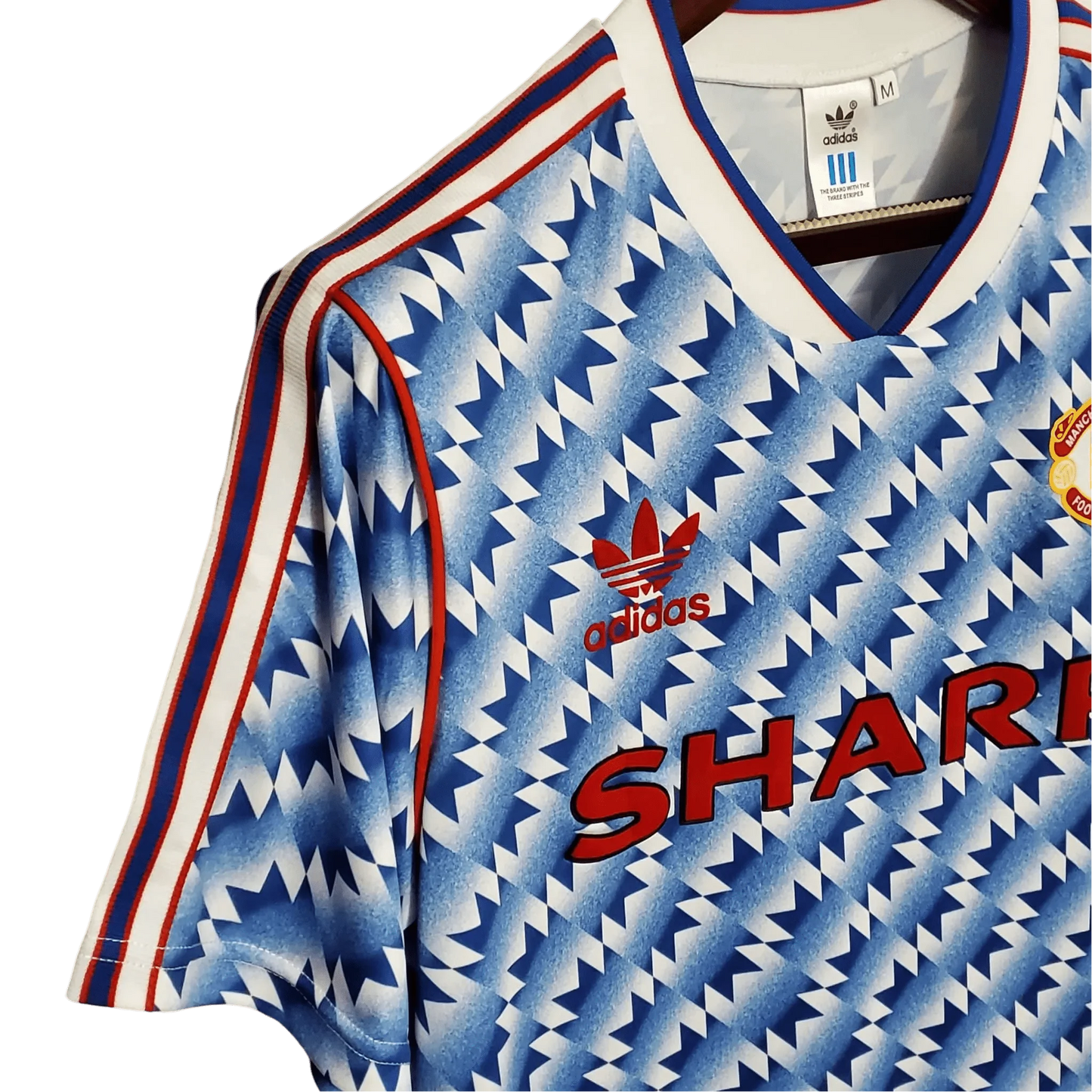 https://cdn.shopify.com/s/files/1/0826/7228/8075/files/19901992-manchester-united-sharp-blue-flower-away-retro-kit-classickits433-960388.webp?v=1741197760