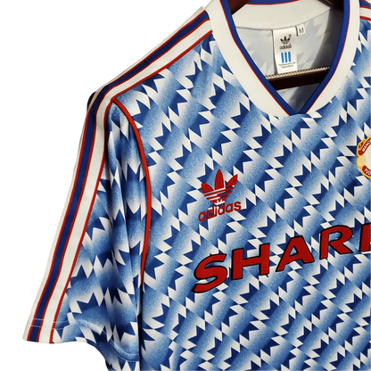 https://cdn.shopify.com/s/files/1/0826/7228/8075/files/19901992-manchester-united-sharp-blue-flower-away-retro-kit-classickits433-960388.webp?v=1741197760