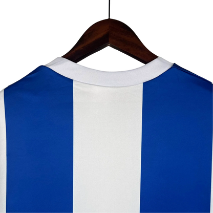 https://cdn.shopify.com/s/files/1/0826/7228/8075/files/19901993-fc-porto-revigres-away-retro-jersey-735046.webp?v=1741199360