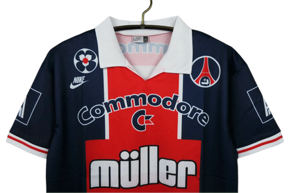 https://cdn.shopify.com/s/files/1/0826/7228/8075/files/19911992-paris-saint-germain-commodore-muller-home-retro-jersey-at-govintagejersey-432501.webp?v=1741199407