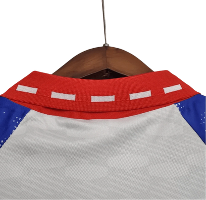 https://cdn.shopify.com/s/files/1/0826/7228/8075/files/19931994-paris-saint-germain-commodore-away-white-retro-981601.webp?v=1741199395