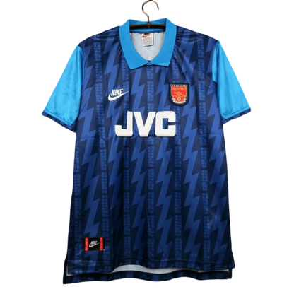 https://cdn.shopify.com/s/files/1/0826/7228/8075/files/19941995-arsenal-jvc-blue-away-retro-kit-classickits433-448433.webp?v=1741198352