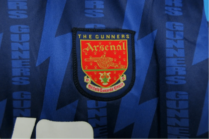 https://cdn.shopify.com/s/files/1/0826/7228/8075/files/19941995-arsenal-jvc-blue-away-retro-kit-classickits433-933622.webp?v=1741198354