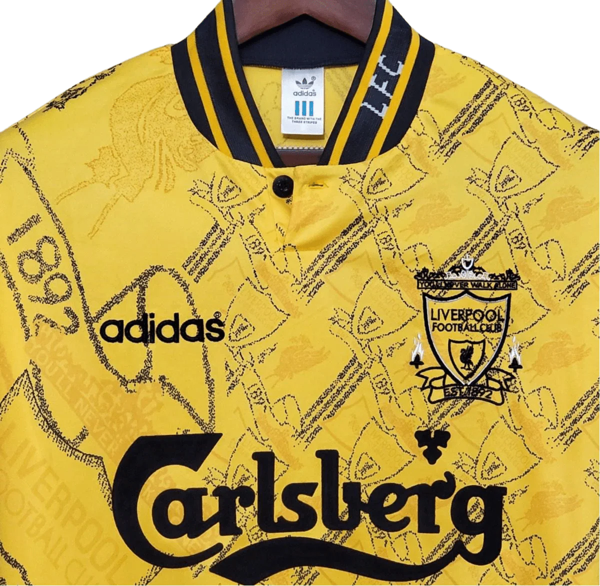 https://cdn.shopify.com/s/files/1/0826/7228/8075/files/19941995-liverpool-carlsberg-yellow-third-retro-kit-classickits433-869160.webp?v=1741199192