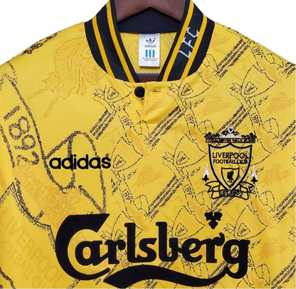 https://cdn.shopify.com/s/files/1/0826/7228/8075/files/19941995-liverpool-carlsberg-yellow-third-retro-kit-classickits433-869160.webp?v=1741199192