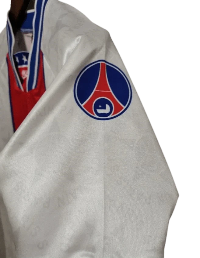 https://cdn.shopify.com/s/files/1/0826/7228/8075/files/19941995-paris-saint-germain-away-white-retro-jersey-995988.webp?v=1741199359