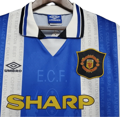 https://cdn.shopify.com/s/files/1/0826/7228/8075/files/19941996-manchester-united-sharp-blue-white-third-retro-kit-classickits433-712124.webp?v=1741199150