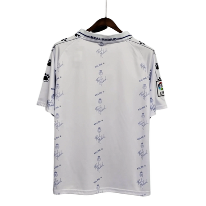 https://cdn.shopify.com/s/files/1/0826/7228/8075/files/19941996-real-madrid-teka-home-retro-kit-230711.webp?v=1741197464