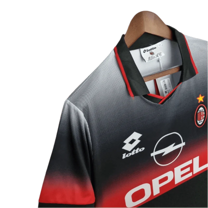 https://cdn.shopify.com/s/files/1/0826/7228/8075/files/19951996-ac-milan-opel-training-black-retro-kit-classickits433-466095.webp?v=1741198817