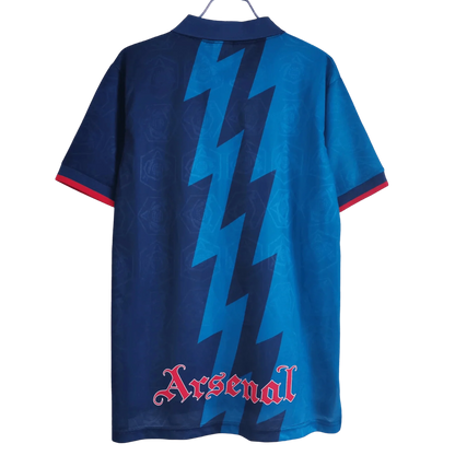 https://cdn.shopify.com/s/files/1/0826/7228/8075/files/19951996-arsenal-jvc-blue-away-retro-kit-classickits433-853342.webp?v=1741199334