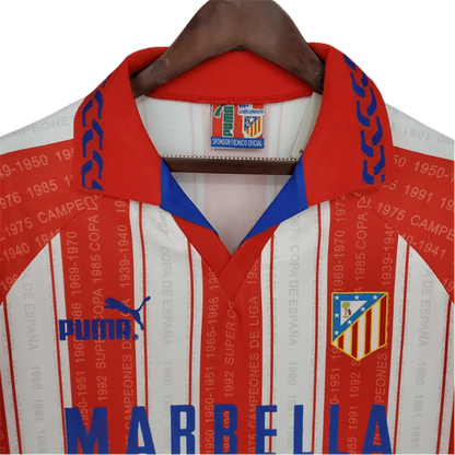 https://cdn.shopify.com/s/files/1/0826/7228/8075/files/19951996-atletico-madrid-marbella-home-retro-kit-classickits433-586094.webp?v=1741199013