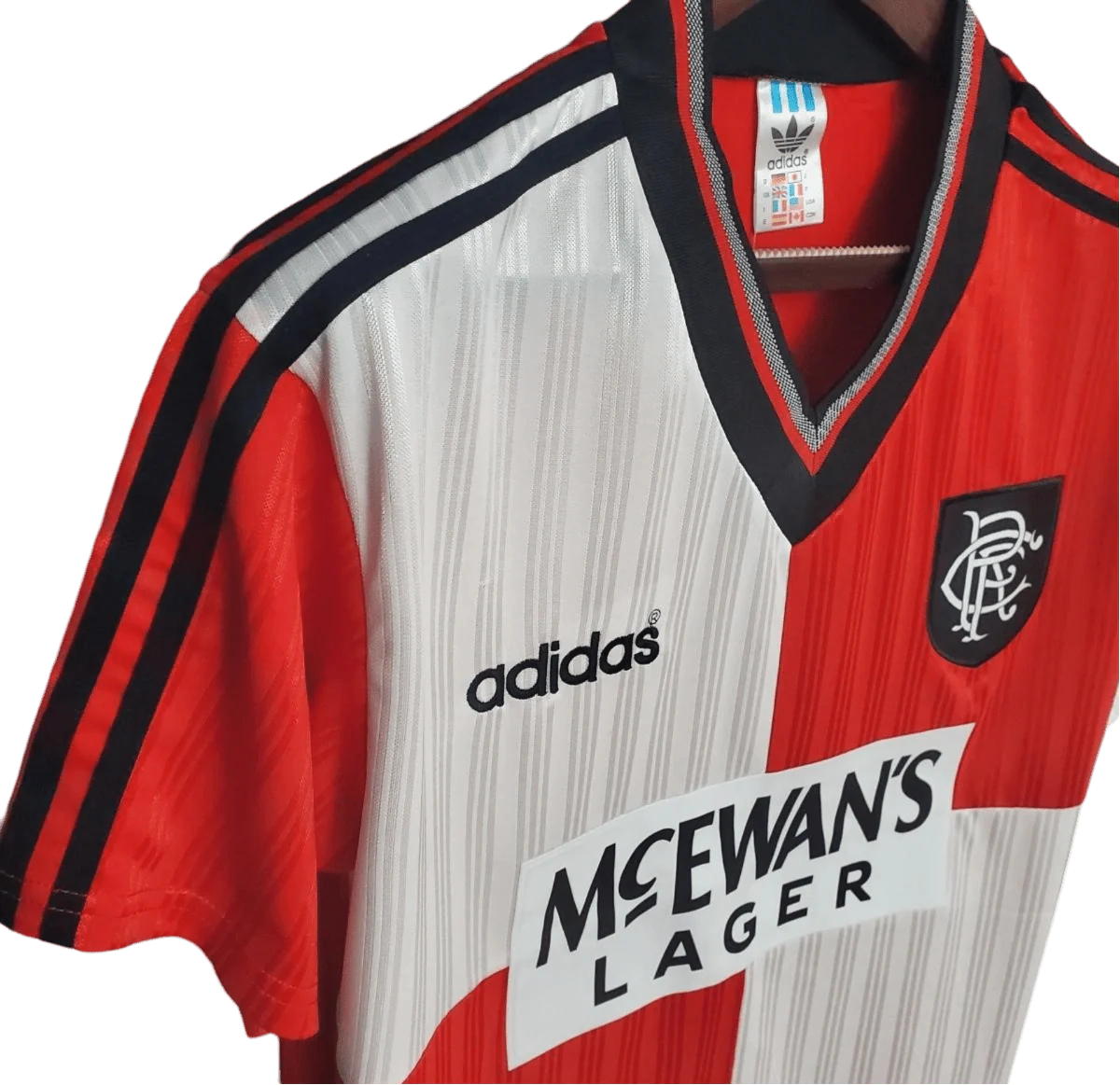 https://cdn.shopify.com/s/files/1/0826/7228/8075/files/19951996-glasgow-rangers-mcewans-lager-away-kit-classickits433-261971.webp?v=1741199016