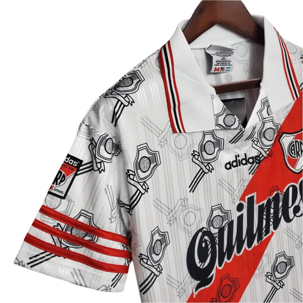 https://cdn.shopify.com/s/files/1/0826/7228/8075/files/19951996-river-plate-quilmes-home-retro-jersey-244702.webp?v=1741197179
