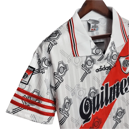 https://cdn.shopify.com/s/files/1/0826/7228/8075/files/19951996-river-plate-quilmes-home-retro-jersey-244702.webp?v=1741197179