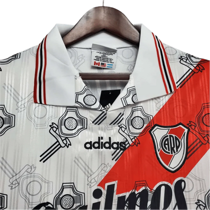 https://cdn.shopify.com/s/files/1/0826/7228/8075/files/19951996-river-plate-quilmes-home-retro-jersey-293865.webp?v=1741197180