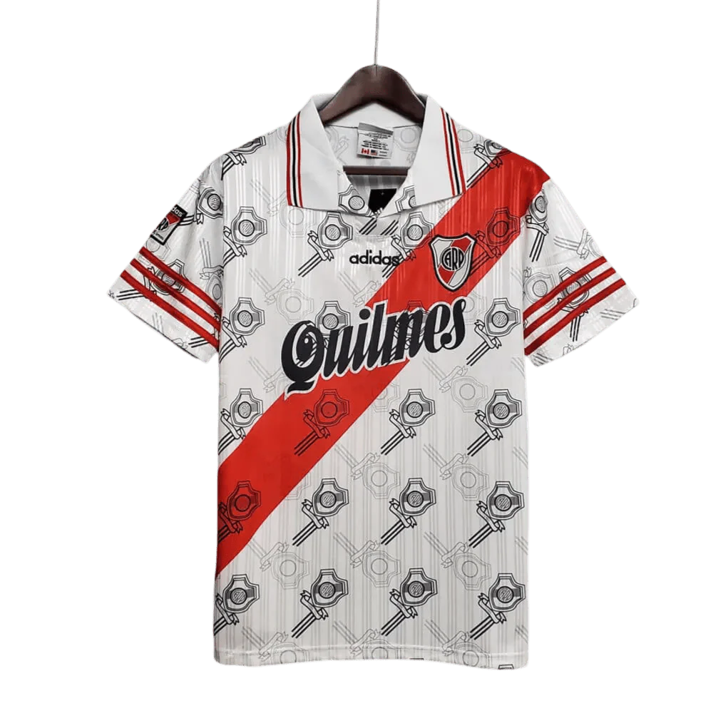 https://cdn.shopify.com/s/files/1/0826/7228/8075/files/19951996-river-plate-quilmes-home-retro-jersey-468382.webp?v=1741197181