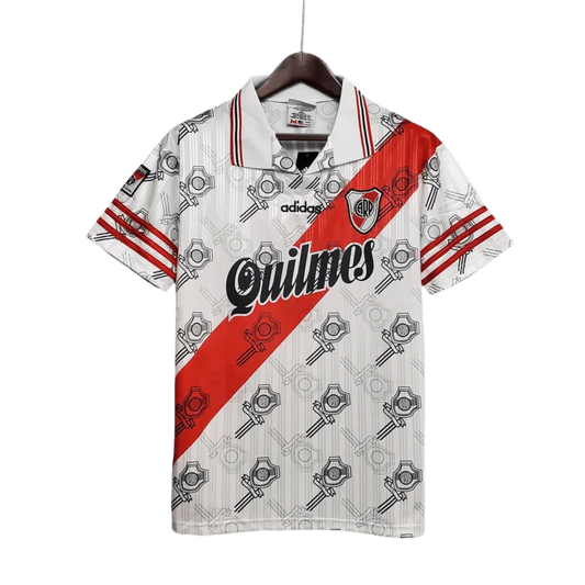 https://cdn.shopify.com/s/files/1/0826/7228/8075/files/19951996-river-plate-quilmes-home-retro-jersey-468382.webp?v=1741197181