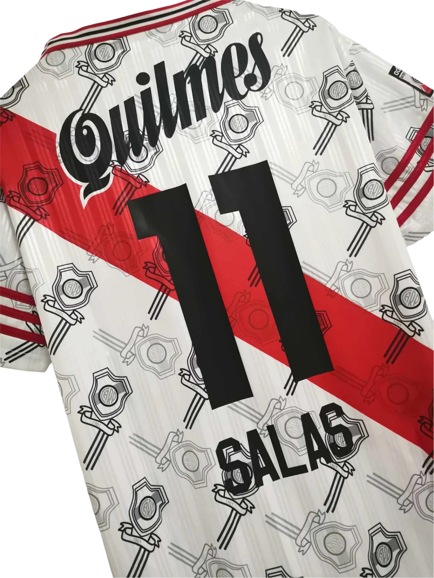 https://cdn.shopify.com/s/files/1/0826/7228/8075/files/19951996-river-plate-quilmes-home-retro-jersey-642829.webp?v=1741197183