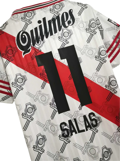 https://cdn.shopify.com/s/files/1/0826/7228/8075/files/19951996-river-plate-quilmes-home-retro-jersey-642829.webp?v=1741197183
