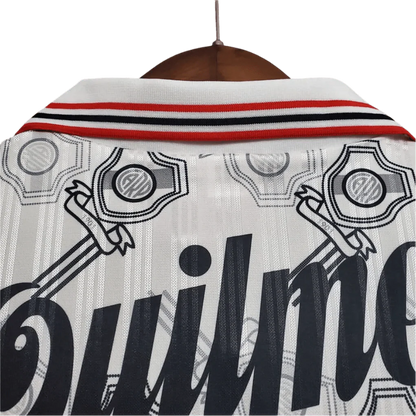 https://cdn.shopify.com/s/files/1/0826/7228/8075/files/19951996-river-plate-quilmes-home-retro-jersey-758478.webp?v=1741197183