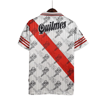 https://cdn.shopify.com/s/files/1/0826/7228/8075/files/19951996-river-plate-quilmes-home-retro-jersey-823538.webp?v=1741197179