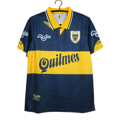 https://cdn.shopify.com/s/files/1/0826/7228/8075/files/19951997-boca-juniors-quilmes-home-retro-jersey-129490.webp?v=1741197187