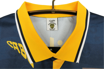 https://cdn.shopify.com/s/files/1/0826/7228/8075/files/19951997-boca-juniors-quilmes-home-retro-jersey-715764.webp?v=1741197188